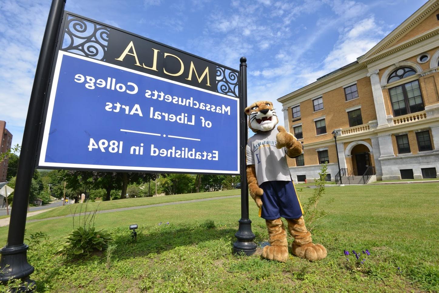 Mascot standing by college sign